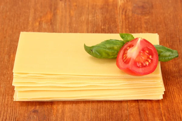 Uncooked lasagna pasta on wooden background — Stock Photo, Image