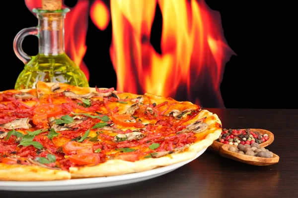 Delicious pizza with vegetables and salami on wooden table — Stock Photo, Image