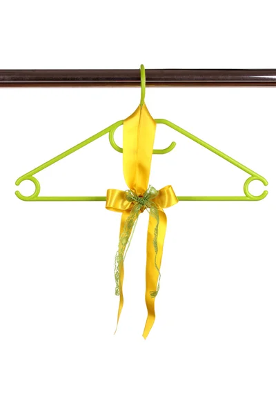 Beautiful yellow bow hanging on wooden hanger isolated on white — Stock Photo, Image