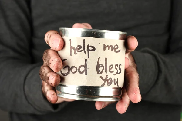 Homeless man asks for help, on black background close-up — Stock Photo, Image