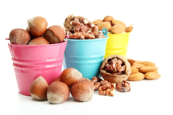 Assortment of tasty nuts in pails, isolated on white — Stock Photo, Image