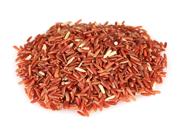 Red rice uncooked in a heap isolated on a white background — Stockfoto