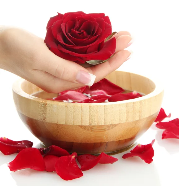 Woman hand with wooden bowl of water with petals, isolated on white — Stock Photo, Image