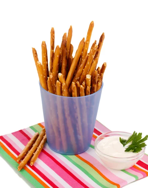 Tasty crispy sticks in purple plastic cup isolated on white — Stock Photo, Image