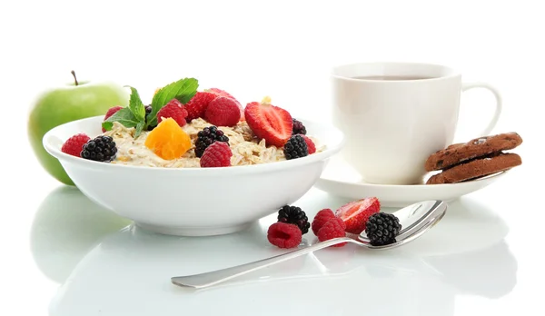 Tasty oatmeal with berries and cup of tea, isolated on white — Stock Photo, Image