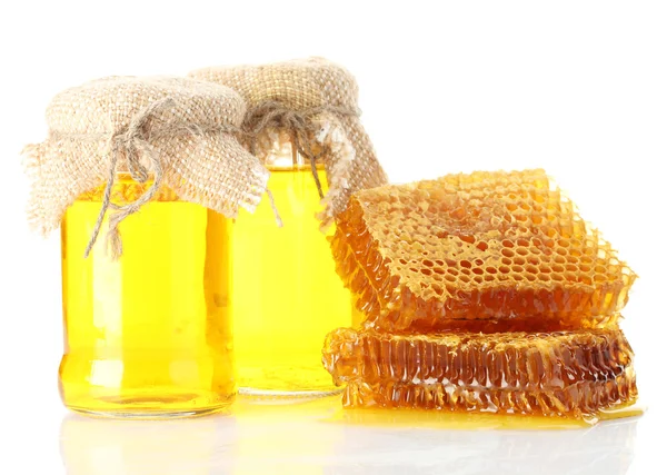 Sweet honeycombs and jars with honey, isolated on white Royalty Free Stock Photos
