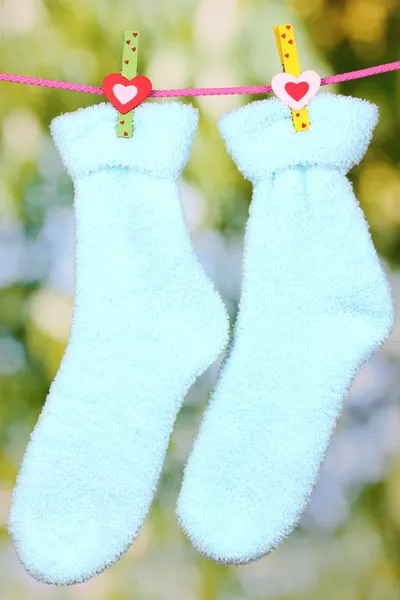Pair of blue socks hanging to dry — Stock Photo, Image