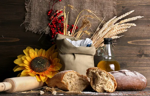 Rye bread on wooden table on wooden background — Stock Photo, Image