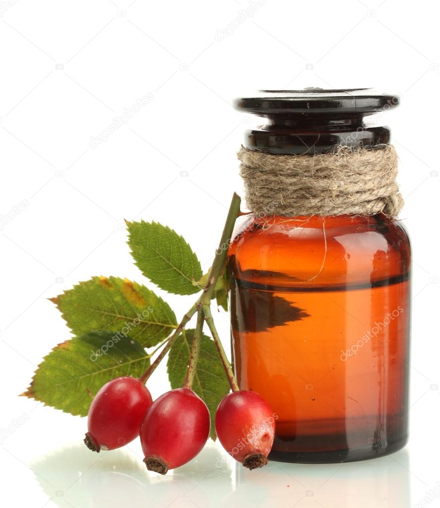 medicine bottle with hip roses, isolated on white