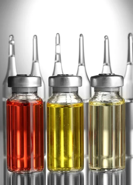 Medical ampules on grey background — Stock Photo, Image