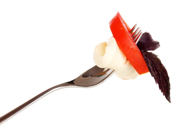 Tasty mozzarella with tomatoes on fork isolated on white — Stock Photo, Image