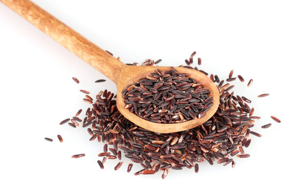 black rice in wooden spoon isolated on white background