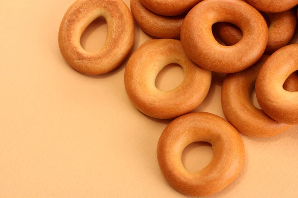 Tasty bagels, on beige background — Stock Photo, Image