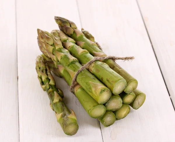 Useful asparagus close-up on wooden table on white background — Stock Photo, Image