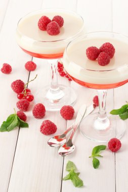 fruit jelly with berries in glasses on wooden table clipart