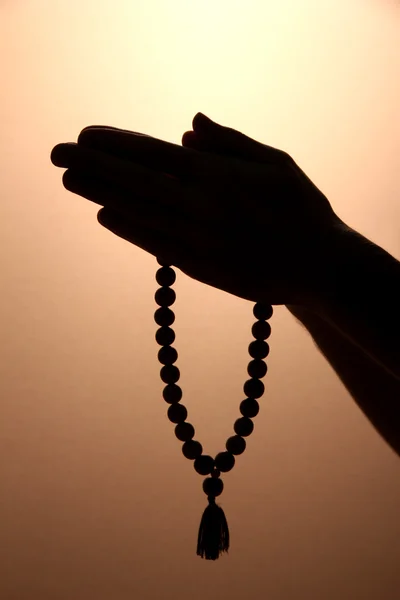 Male hands with rosary, on brown background — Stock Photo, Image