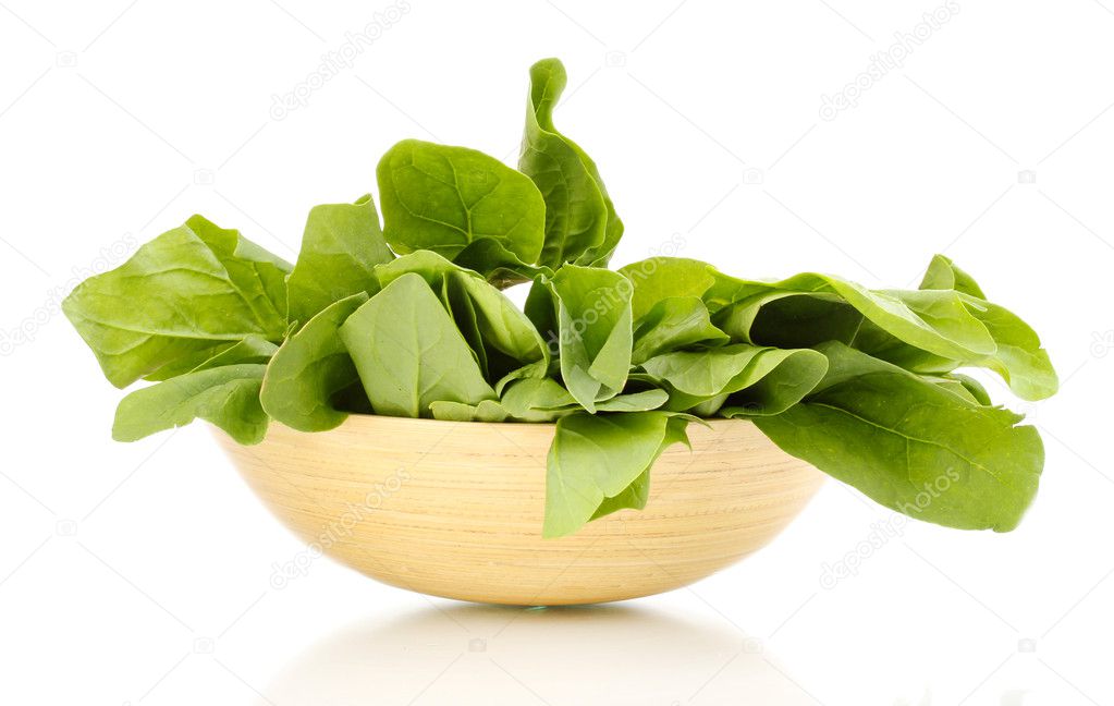 Fresh spinach in wooden bowl isolated on white