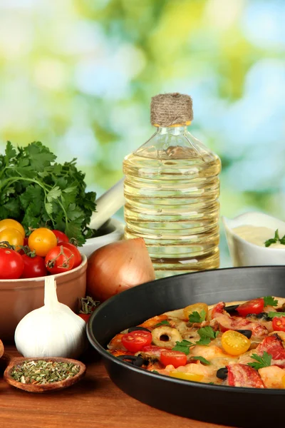 Colorful composition of delicious pizza, vegetables and spices on wooden ba — Stock Photo, Image