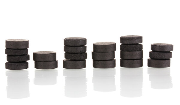 activated carbon in tablets isolated on white