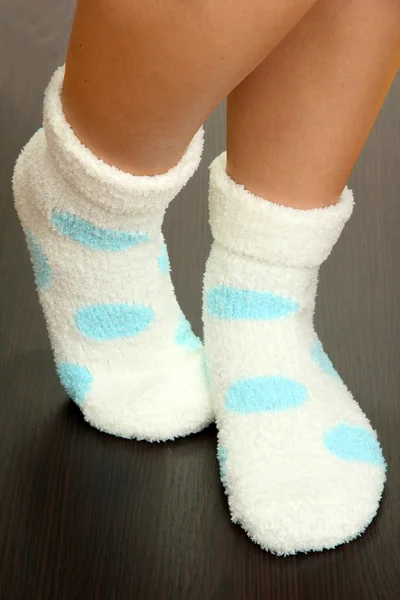 Legs female in socks with polka dots on laminate floor — Stock Photo, Image