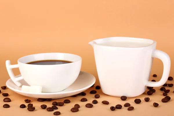 A cup of strong coffee and sweet cream on beige background — Stock Photo, Image