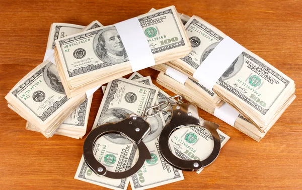 Idea of punishment for financial fraud, on wooden background — Stock Photo, Image