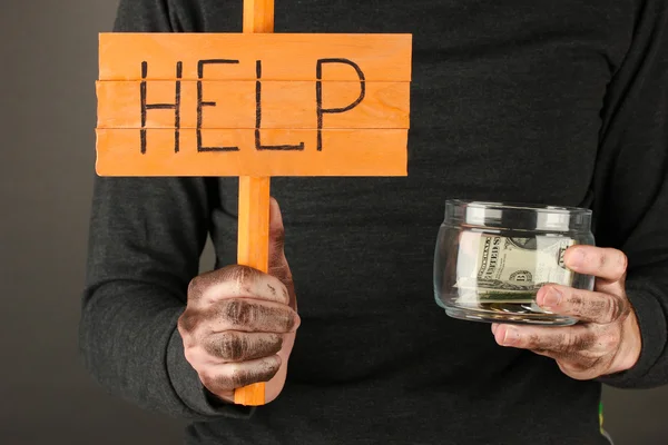 Homeless man asks for help, on black background close-up — Stock Photo, Image