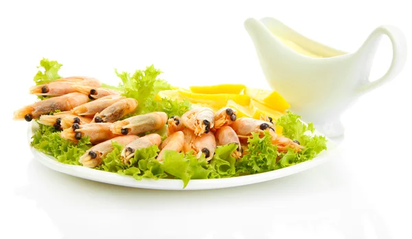 Boiled shrimps with lemon and lettuce leaves on plate and sauce, isolated o — Stock Photo, Image