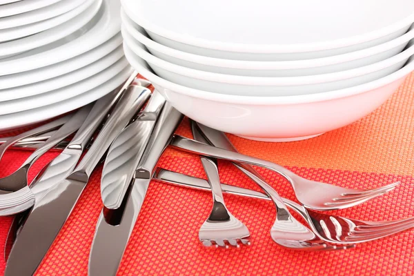 Fourchettes, couteaux et cuillères sur tapis rouge close-up — Photo