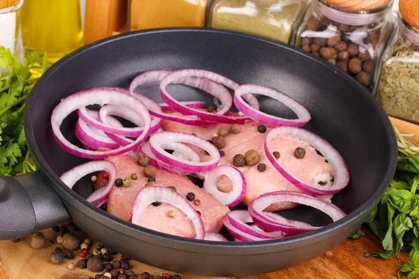 A pieces of pork with onions fried in pan with herbs, spices and cooking oi — Stock Photo, Image