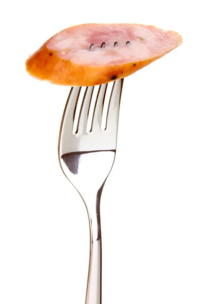 Tasty sausage on fork isolated on white — Stock Photo, Image
