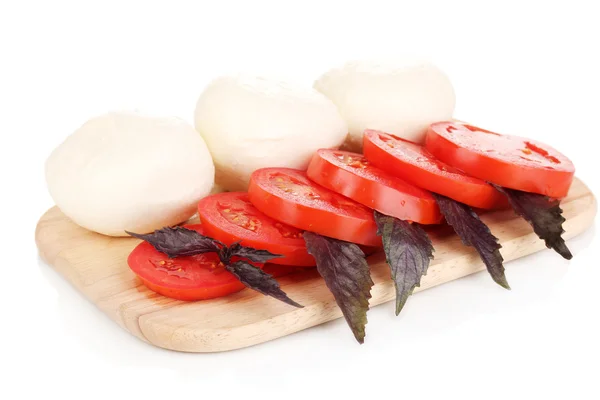 Tasty mozzarella with tomatoes on chopping board isolated on white — Stock Photo, Image