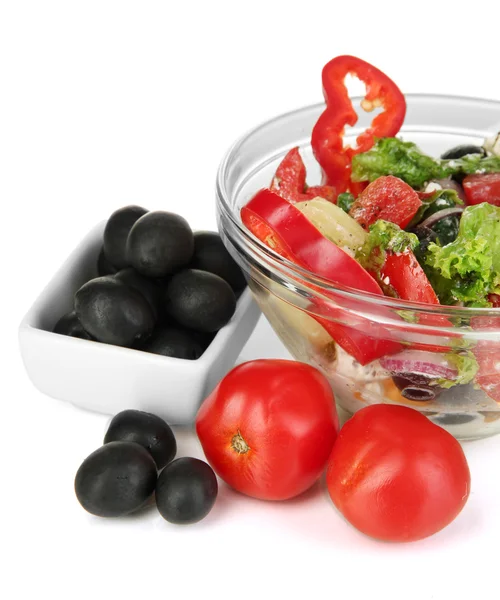 Fresh greek salad in glass bowl isolated on white — Stock Photo, Image