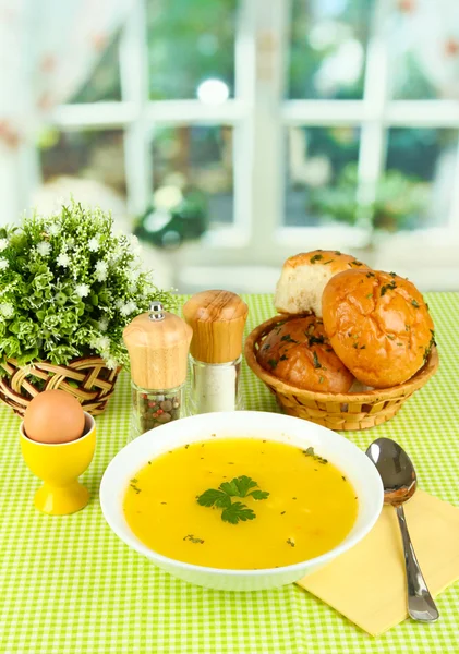 Fragrant soup in white plate on green tablecloth on window background close — Stock Image Fragrant soup in white plate on green tablecloth on window background close Royalty Free Stock Photos