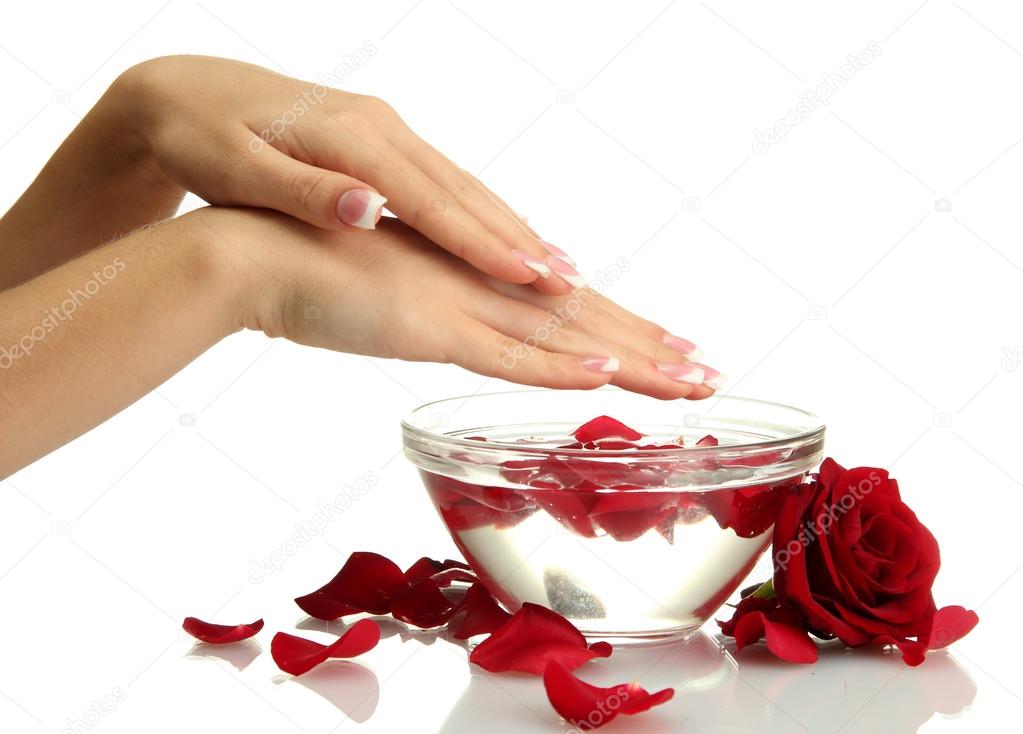 woman hands with glass bowl of water with petals, isolated on white