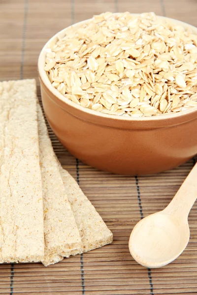 Brown bowl full of oat flakes isolated on white — Stock Photo, Image