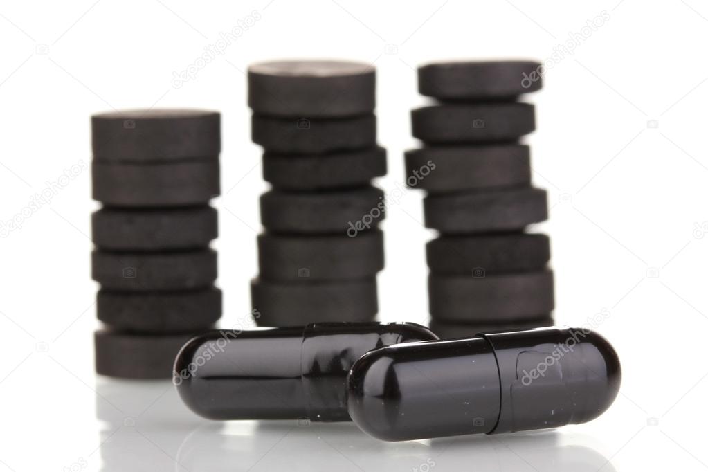 activated carbon in tablets isolated on white