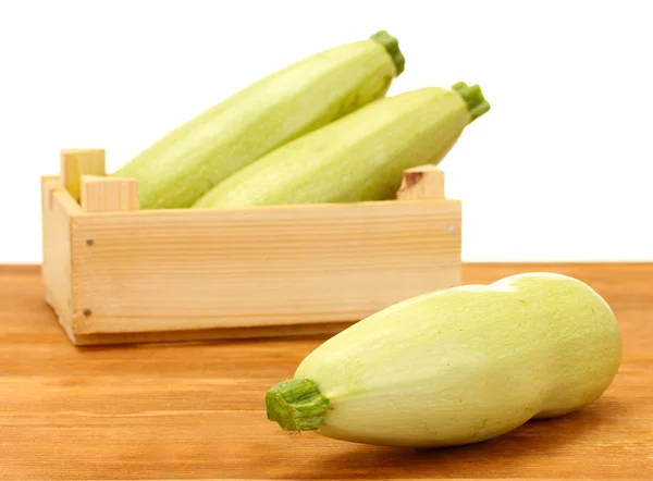 Squash in a box on wooden table on white background close-up — Stock Photo, Image