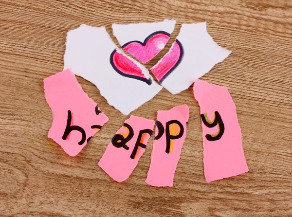 Torn paper with words Happy close-up on wooden table — Stock Photo, Image