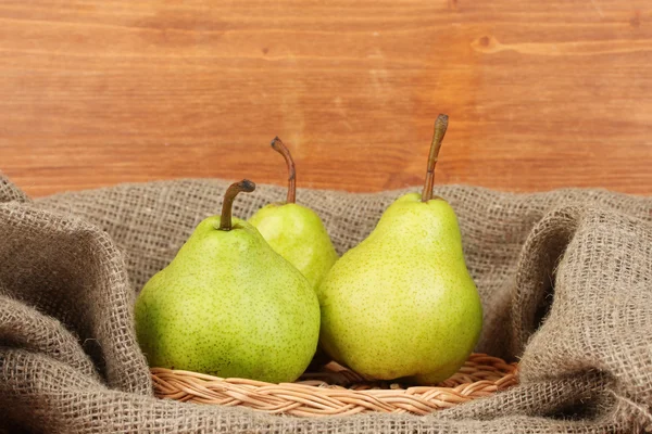 Reife Birnen im Sack auf hölzernem Hintergrund Nahaufnahme — Stockfoto