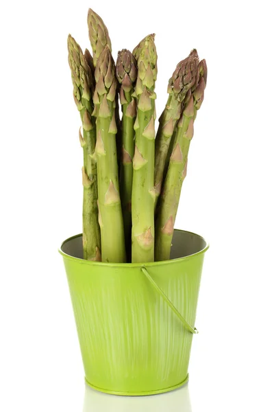 Fresh asparagus in green pail isolated on white — Stock Photo, Image