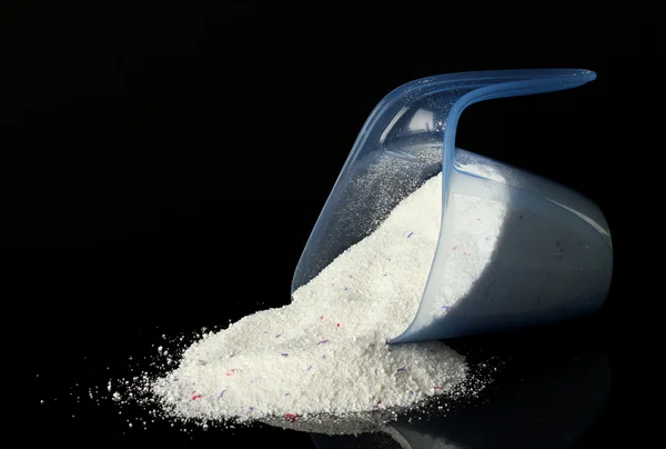 Washing powder in a measuring cup, isolated on black — Stock Photo, Image