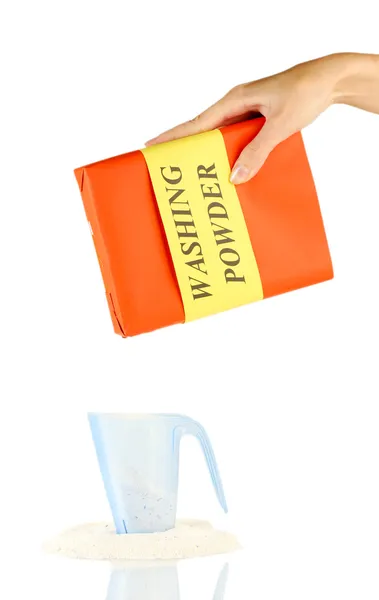 Woman's hand pours laundry detergent in a blue measuring cup, on white background close-up — Stock Photo, Image