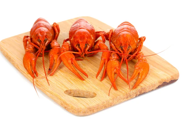 Tasty boiled crayfishes on chopping board isolated on white — Stock Photo, Image