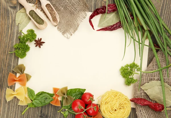 Paper for recipes vegetables, and spices on wooden table — Stock Photo, Image