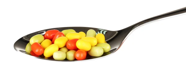 Colorful pills on spoon on white background close-up — Stock Photo, Image