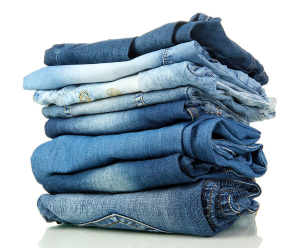 Lot of different blue jeans isolated on white