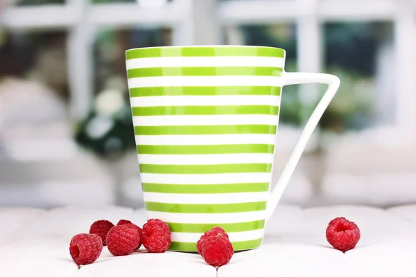 Tea with raspberries on table on bright background — Stock Photo, Image
