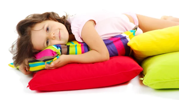 Linda menininha com travesseiros isolados no branco — Fotografia de Stock