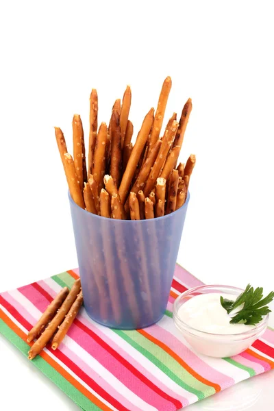 Tasty crispy sticks in purple plastic cup isolated on white — Stock Photo, Image